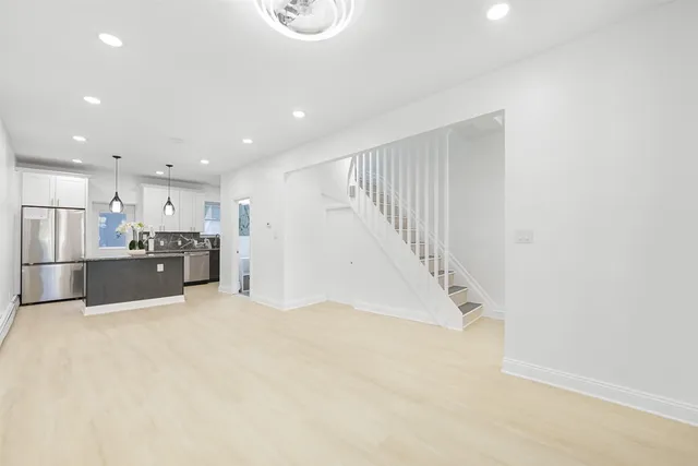 a view of kitchen with stainless steel appliances a refrigerator and a microwave