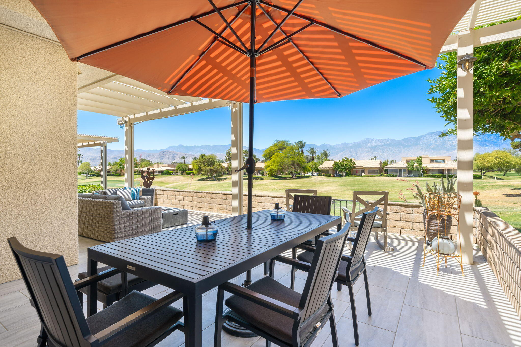 93 Augusta Drive Rancho Mirage, CA 92270 - Photo 23 of 39 a view of a patio with a table and chairs