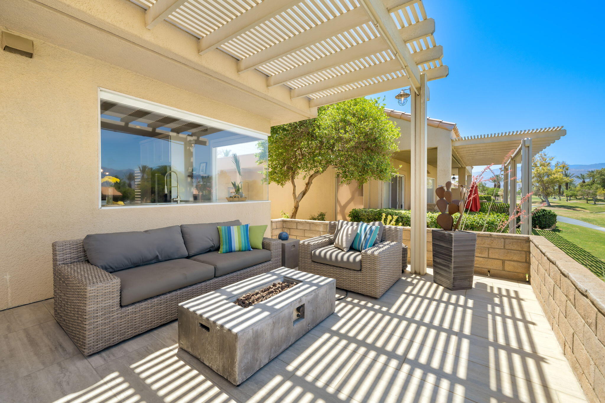 93 Augusta Drive Rancho Mirage, CA 92270 - Photo 25 of 39 a view of a patio with couches and a table and chairs with wooden floor