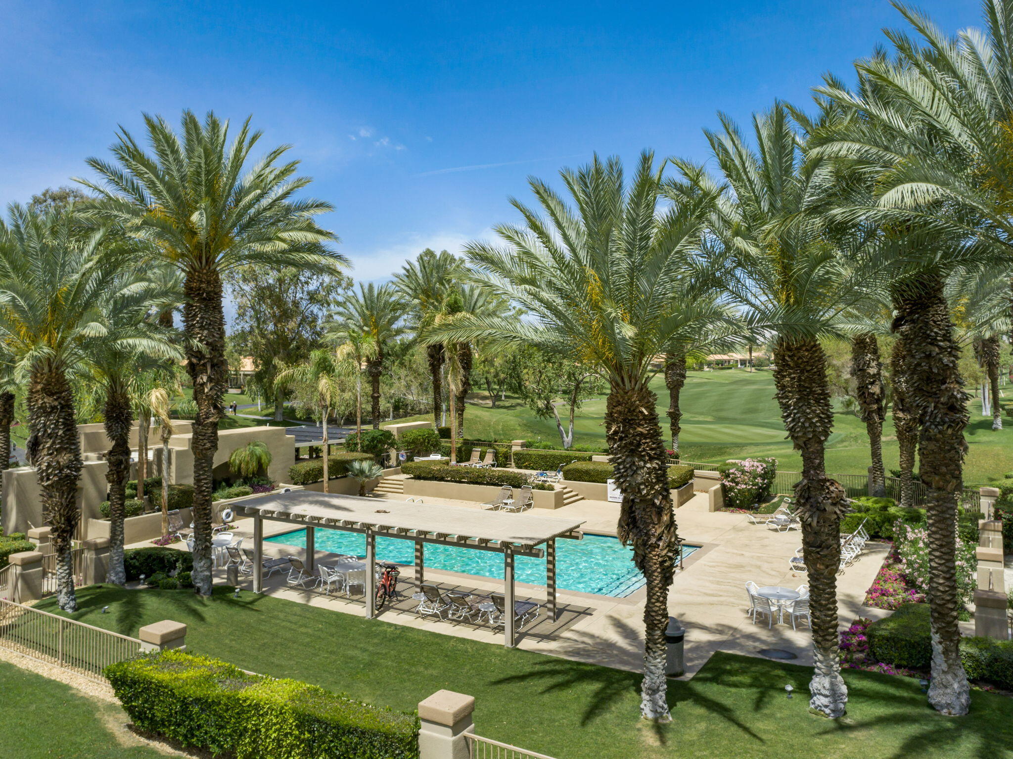 93 Augusta Drive Rancho Mirage, CA 92270 - Photo 38 of 39 a view of a swimming pool with lawn chairs and a fire pit