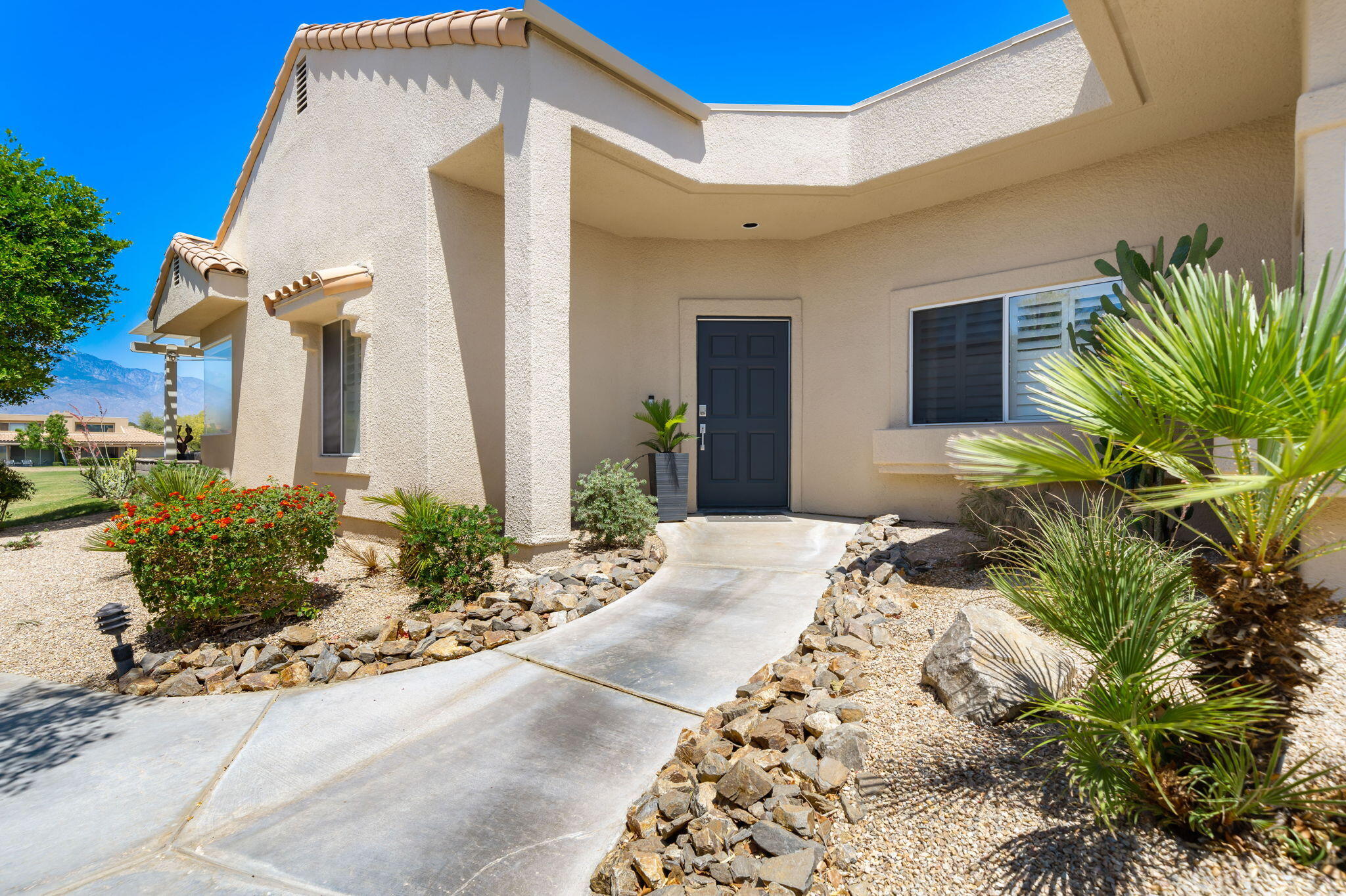 93 Augusta Drive Rancho Mirage, CA 92270 - Photo 9 of 39 a view of a house with potted plants