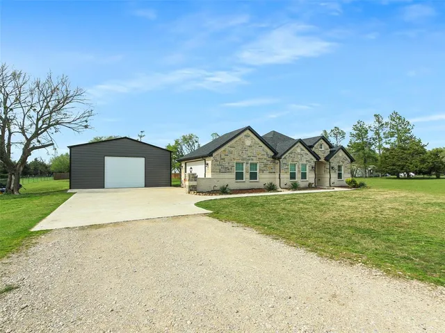 a front view of house with yard and green space