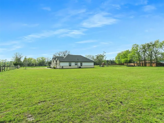 a view of a green field with clear sky