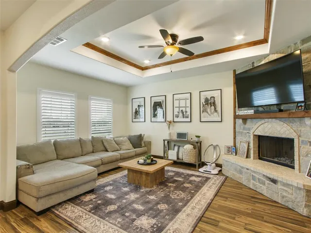 a living room with furniture a flat screen tv and a fireplace