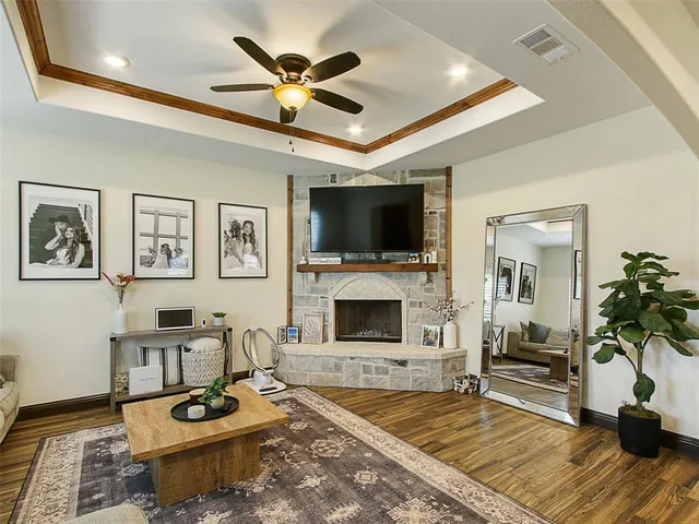 a living room with furniture a flat screen tv and a fireplace