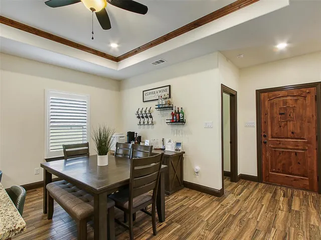 a view of a dining room with furniture and wooden floor