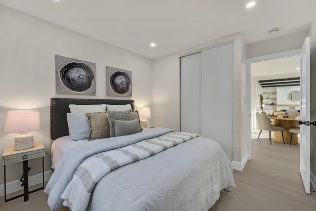 a bedroom with a bed and a lamp on table