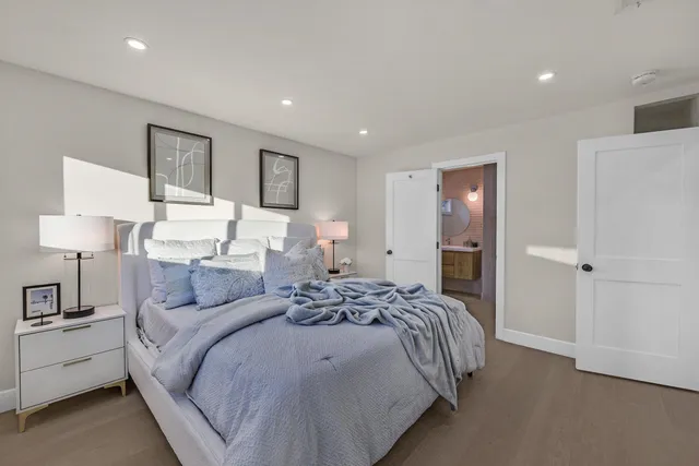 a bedroom with a bed and a lamp