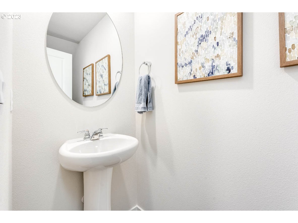 907 Northwest 174th Street Ridgefield, WA 98642 - Photo 13 of 26 a bathroom with a sink and a mirror