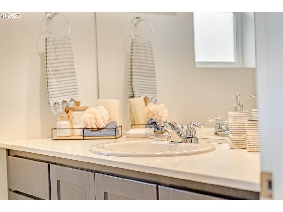 907 Northwest 174th Street Ridgefield, WA 98642 - Photo 26 of 26 a bathroom with a sink and a mirror