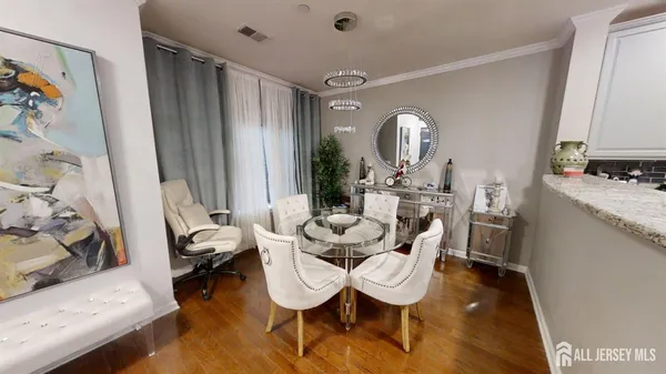 a dining room with furniture and a window