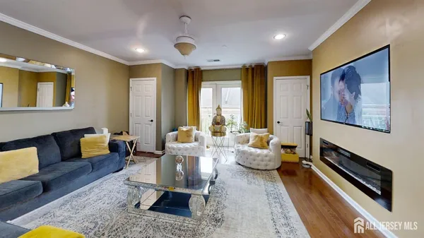 a living room with furniture and wooden floor
