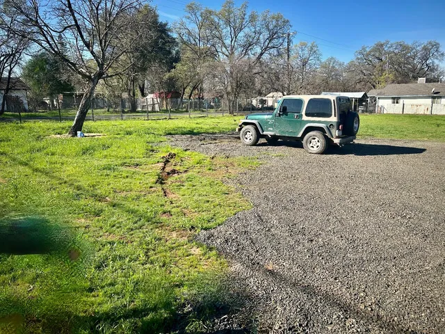 a view of a backyard with a car parked