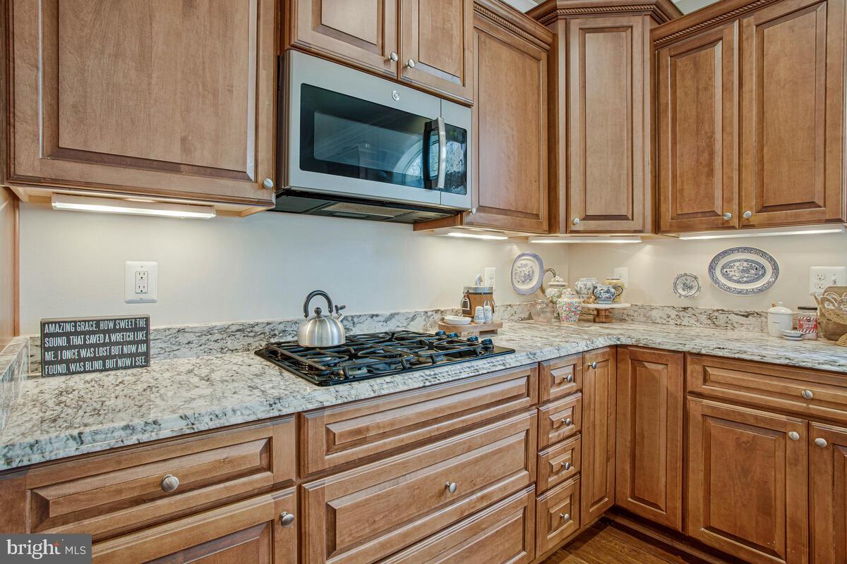 54 Simmons Ridge Road Prince Frederick, MD 20678 - Photo 23 of 55 a kitchen with stainless steel appliances granite countertop white cabinets and a stove top oven