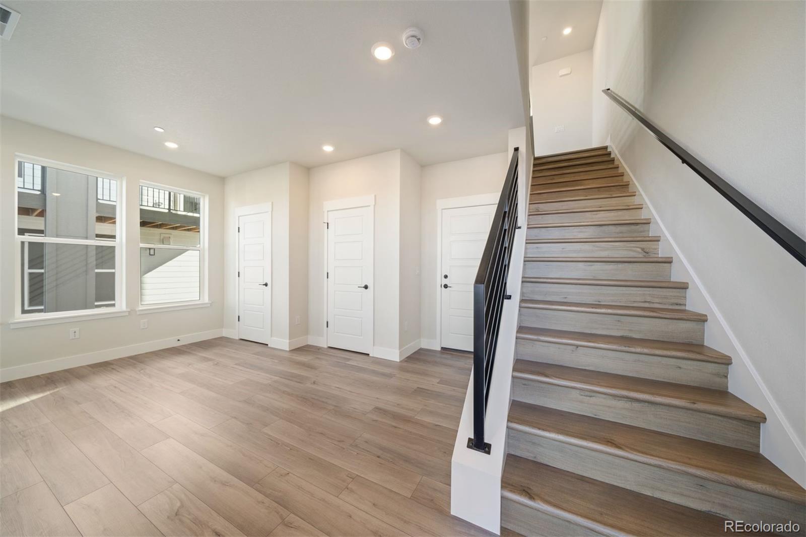 10882 Lyric Street Parker, CO 80134 - Photo 13 of 25 a view of an entryway with wooden floor
