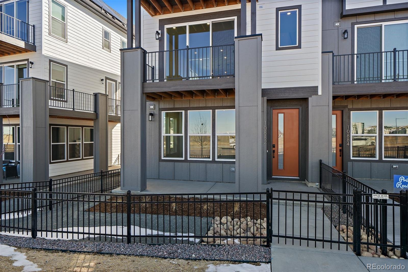 10882 Lyric Street Parker, CO 80134 - Photo 2 of 25 a view of a brick house with a large windows