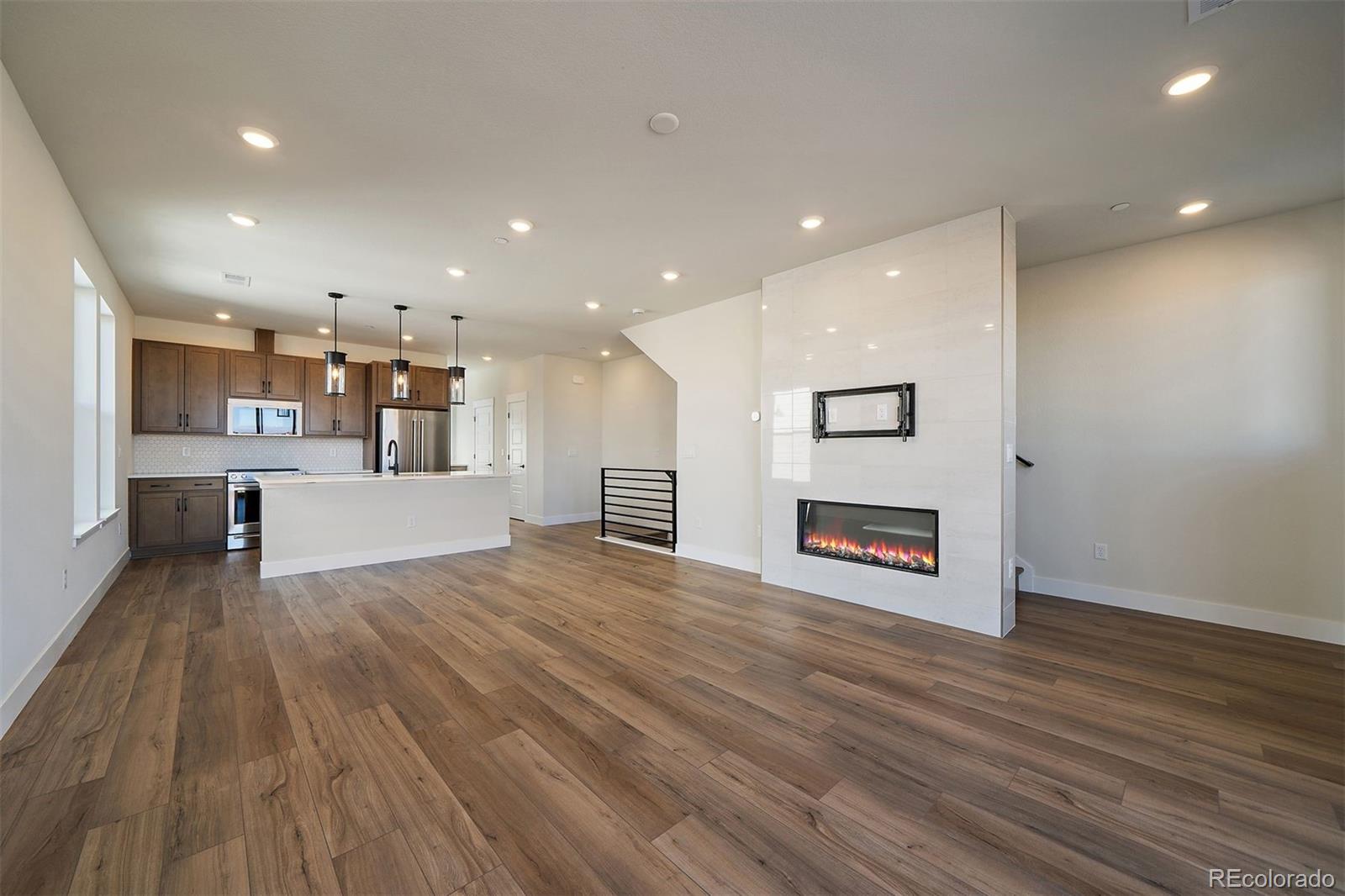 10882 Lyric Street Parker, CO 80134 - Photo 8 of 25 a view of kitchen with cabinets and wooden floor