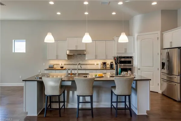 a kitchen that has a table and chairs in it