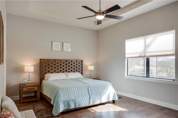 a bedroom with a large bed and a window