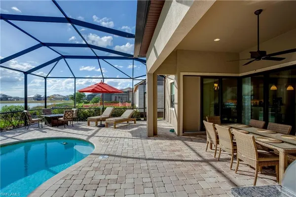 a view of a patio with a table and chairs under an umbrella