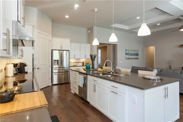 a kitchen with white cabinets and stainless steel appliances