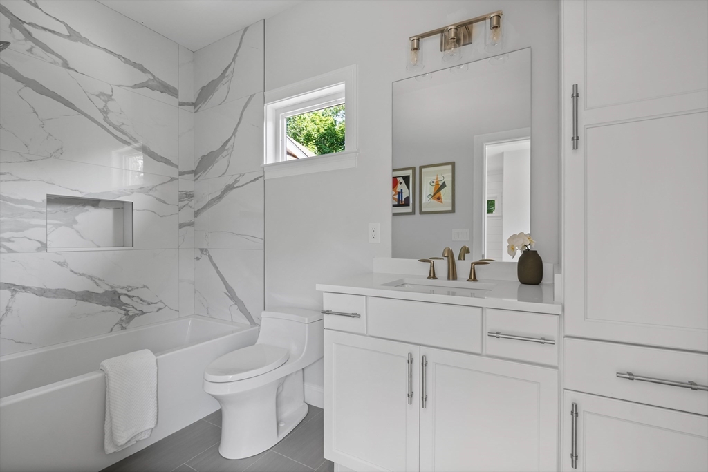 103 Wayne Road Needham, MA 02494 - Photo 20 of 29 a bathroom with a toilet sink and mirror