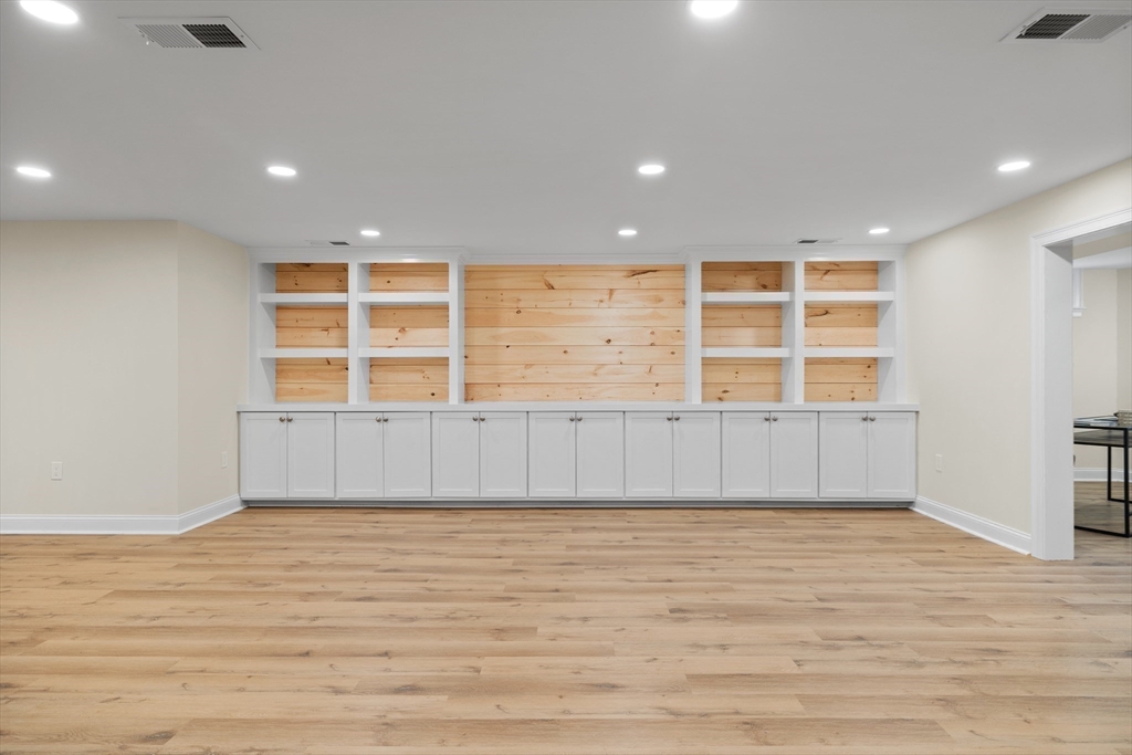 103 Wayne Road Needham, MA 02494 - Photo 22 of 29 an empty room with wooden floor and windows