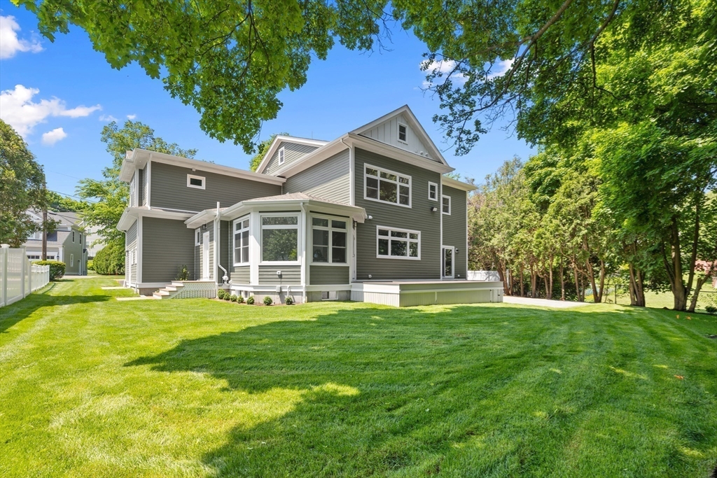 103 Wayne Road Needham, MA 02494 - Photo 23 of 29 a view of a house with a big yard and large trees