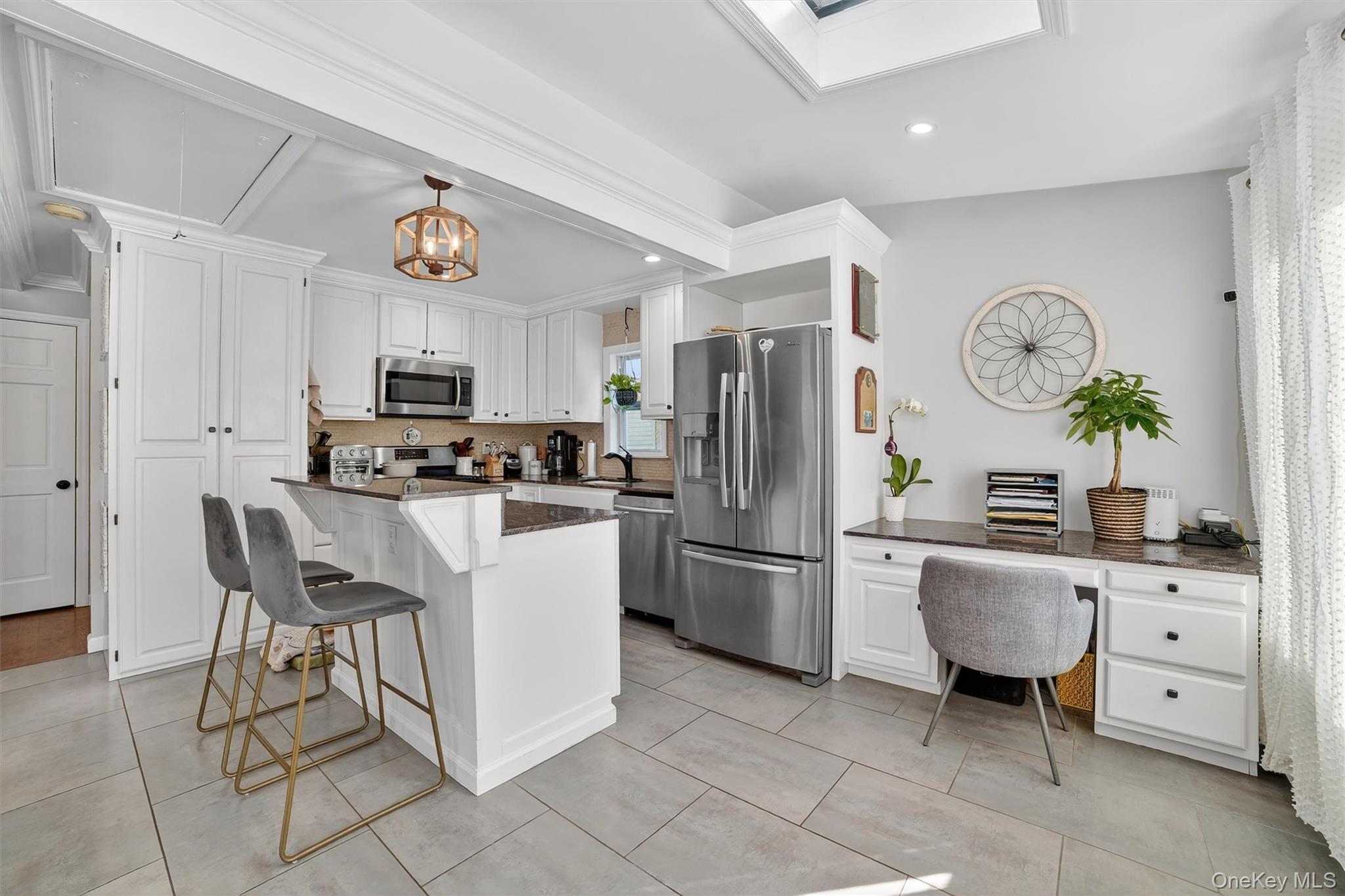 40 Orchard Road Putnam Valley, NY 10579 - Photo 11 of 19 a kitchen with white cabinets and stainless steel appliances
