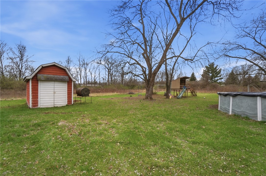 290 Ginghamsburg Road Tipp City, OH 45371 - Photo 48 of 49 This spacious backyard offers ample green space and a convenient storage shed.