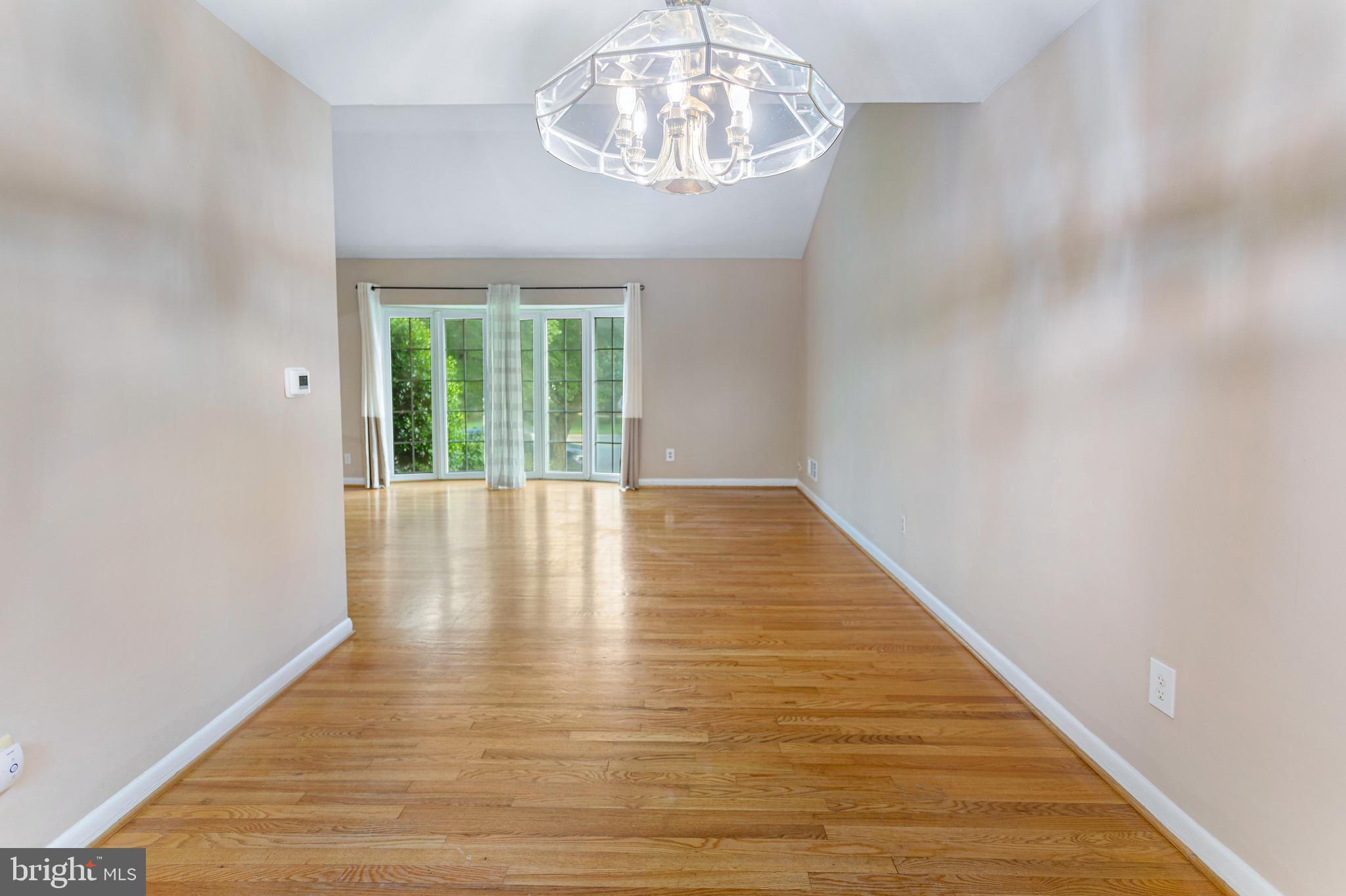6503 Friars Court Bethesda, MD 20817 - Photo 14 of 48 a view of an empty room with wooden floor and a window