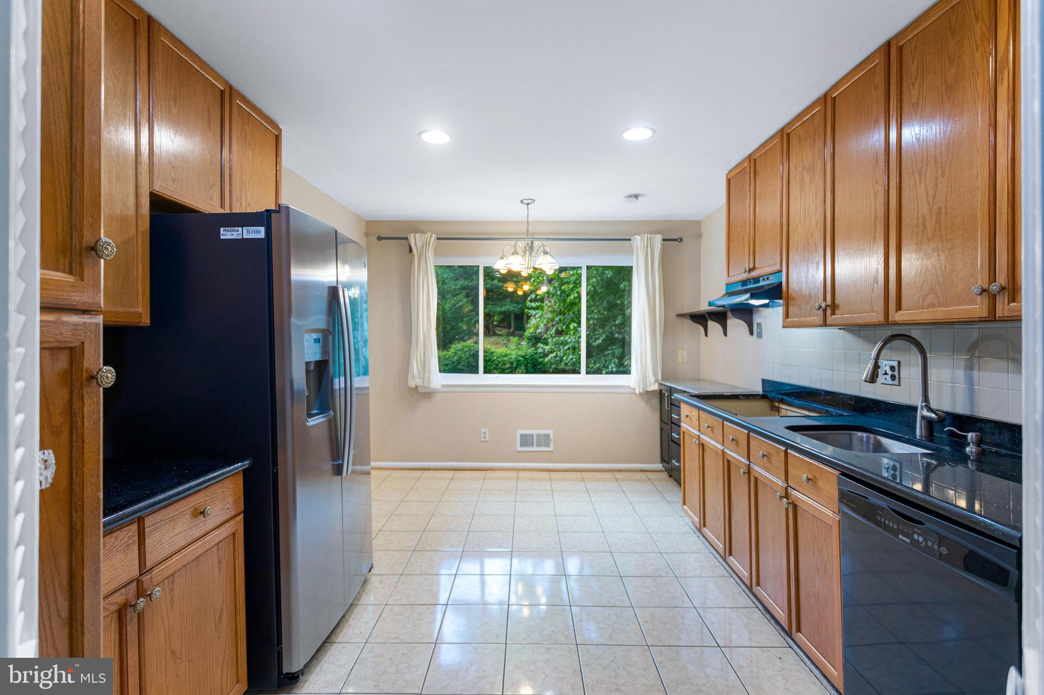 6503 Friars Court Bethesda, MD 20817 - Photo 16 of 48 a large kitchen with stainless steel appliances granite countertop a refrigerator and a sink