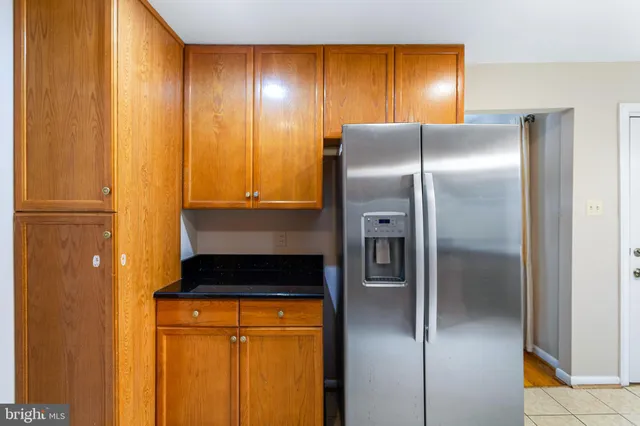 a metallic refrigerator freezer sitting in a kitchen
