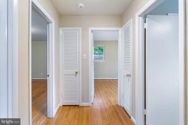 a view of hallway with wooden floor