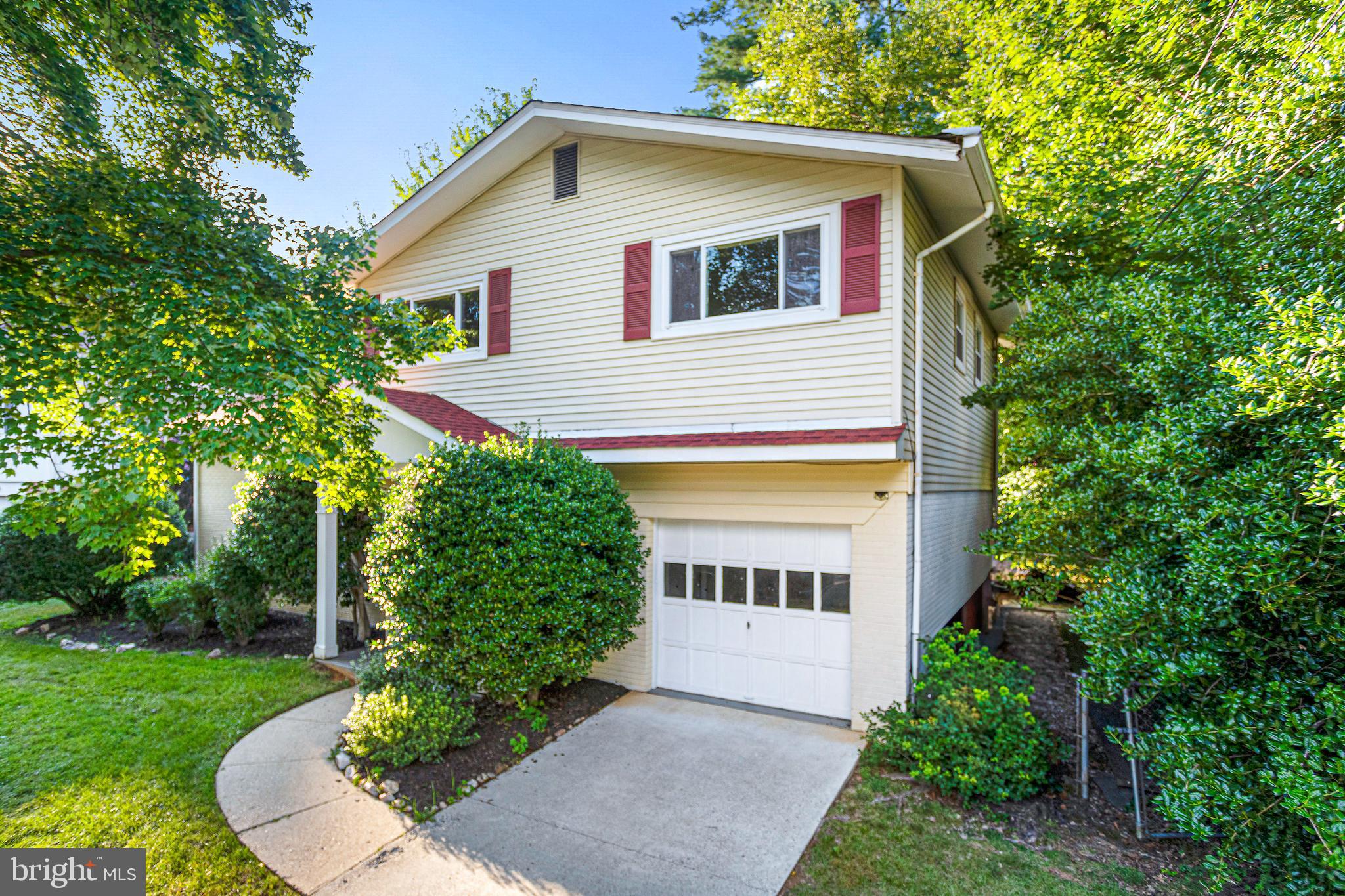 6503 Friars Court Bethesda, MD 20817 - Photo 2 of 48 a front view of a house with a yard garage and outdoor seating