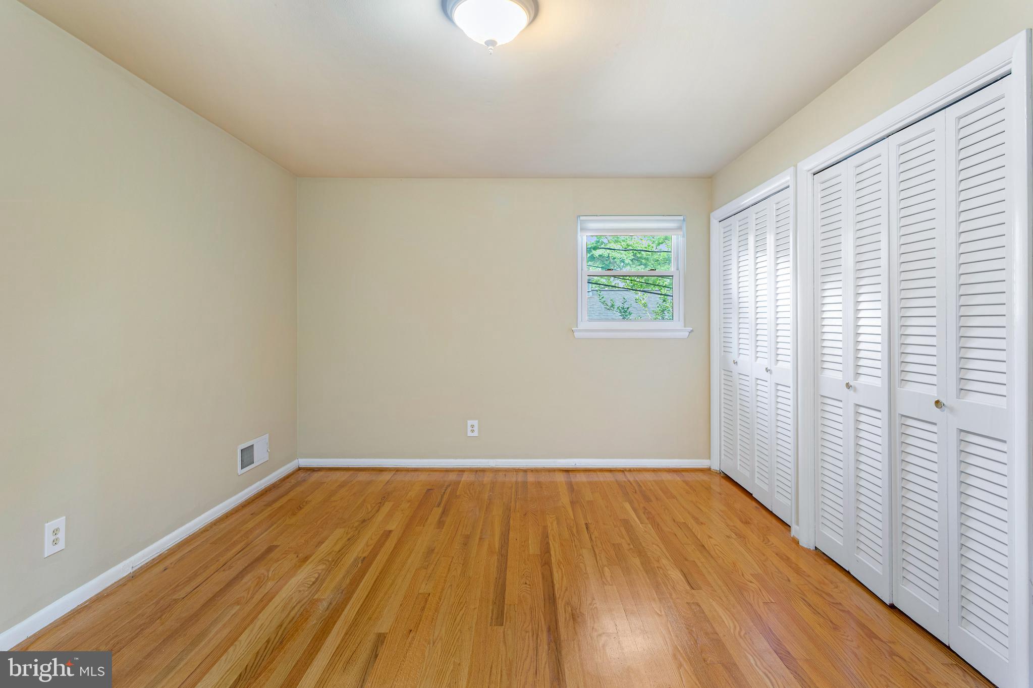 6503 Friars Court Bethesda, MD 20817 - Photo 21 of 48 an empty room with wooden floor and windows