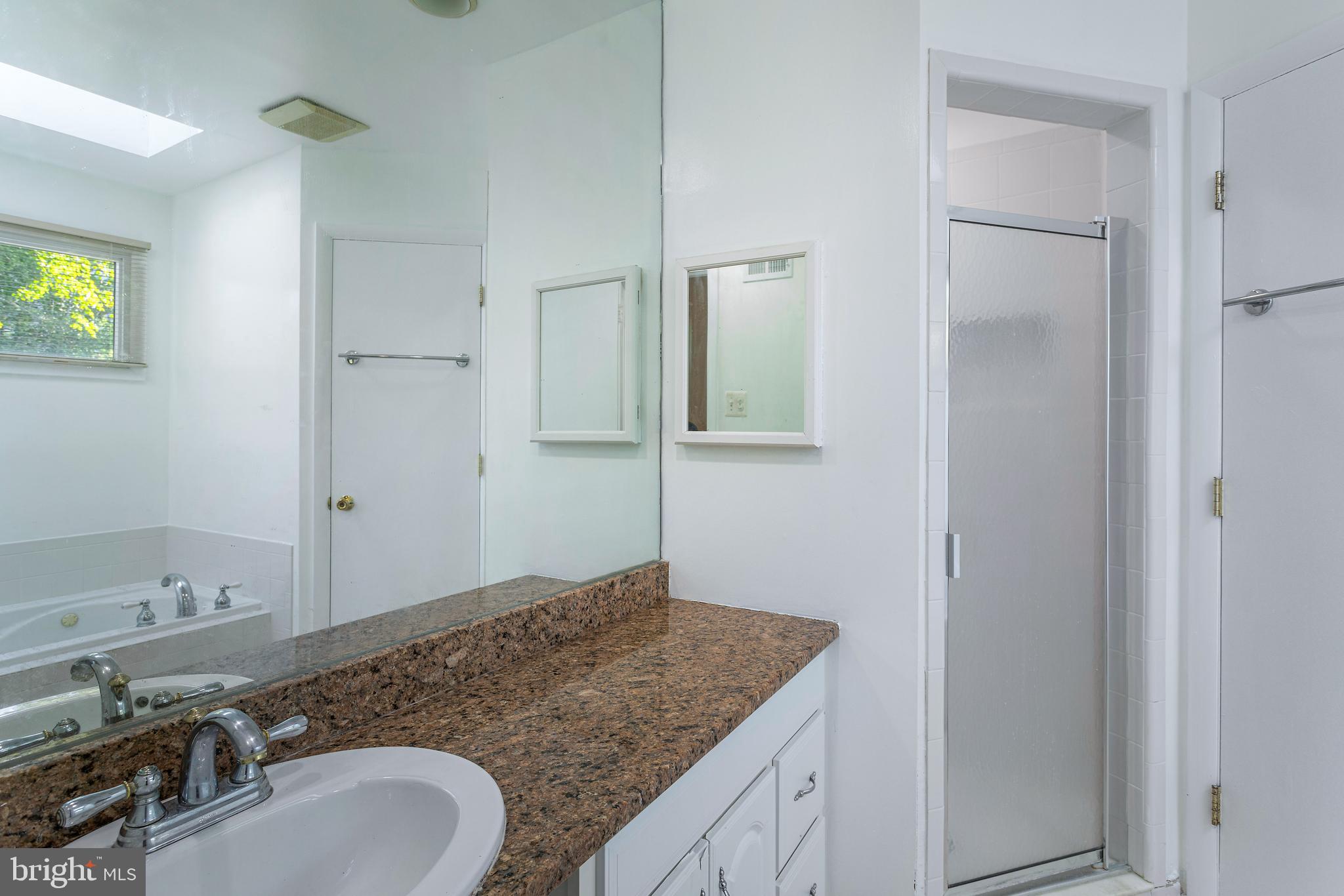 6503 Friars Court Bethesda, MD 20817 - Photo 23 of 48 a bathroom with a granite countertop sink and a mirror