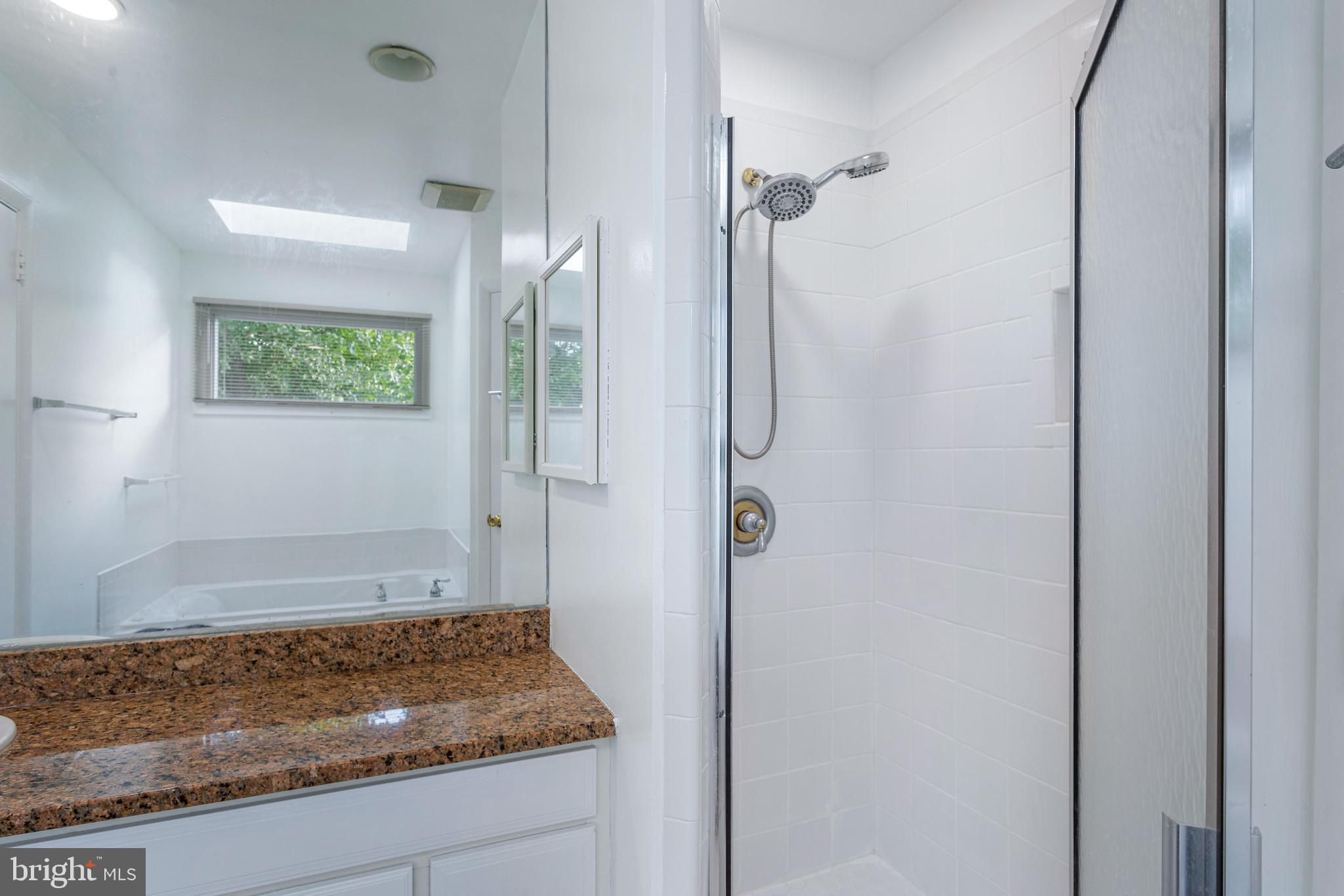6503 Friars Court Bethesda, MD 20817 - Photo 24 of 48 a bathroom with a granite countertop shower