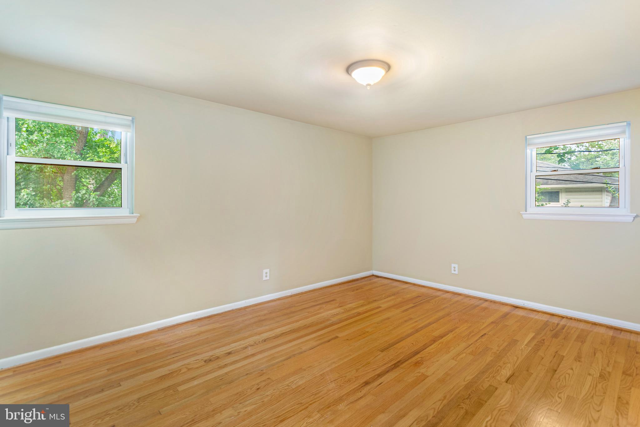 6503 Friars Court Bethesda, MD 20817 - Photo 27 of 48 an empty room with wooden floor and windows