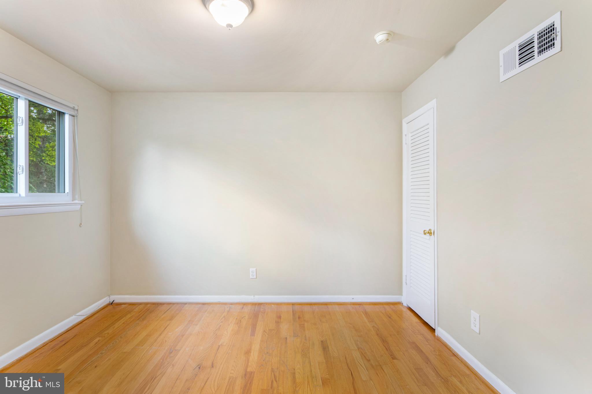 6503 Friars Court Bethesda, MD 20817 - Photo 28 of 48 an empty room with wooden floor and windows