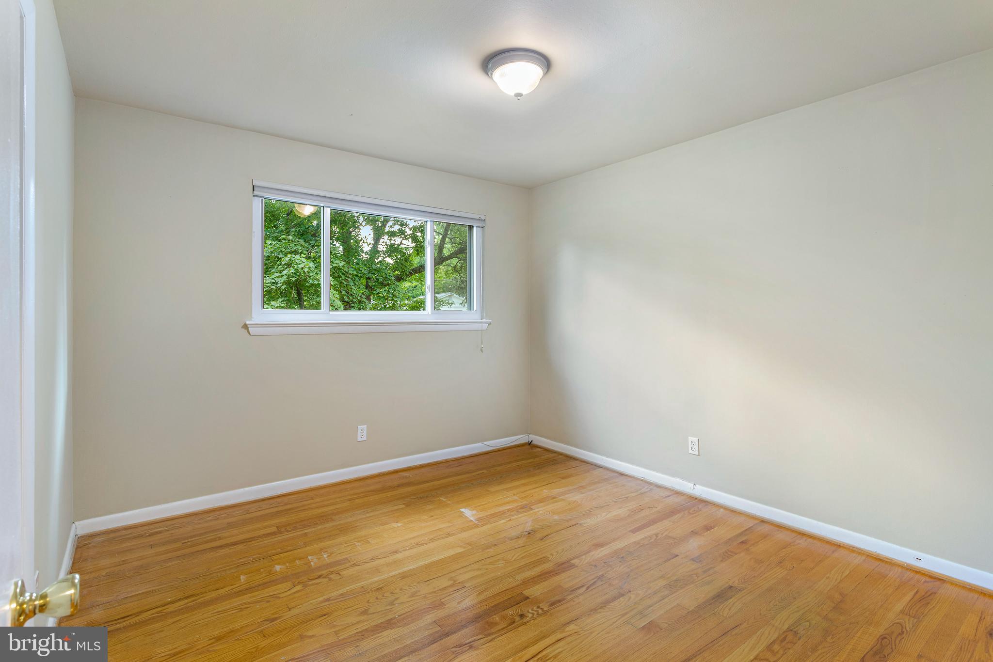 6503 Friars Court Bethesda, MD 20817 - Photo 30 of 48 an empty room with wooden floor and windows