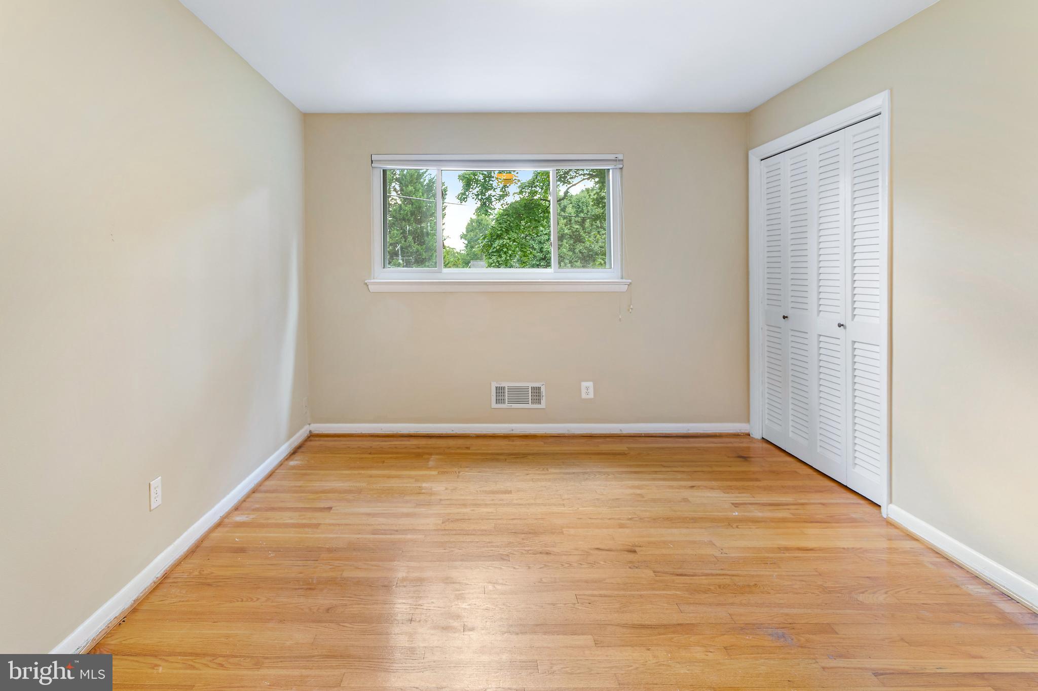6503 Friars Court Bethesda, MD 20817 - Photo 32 of 48 a view of an empty room with wooden floor and a window