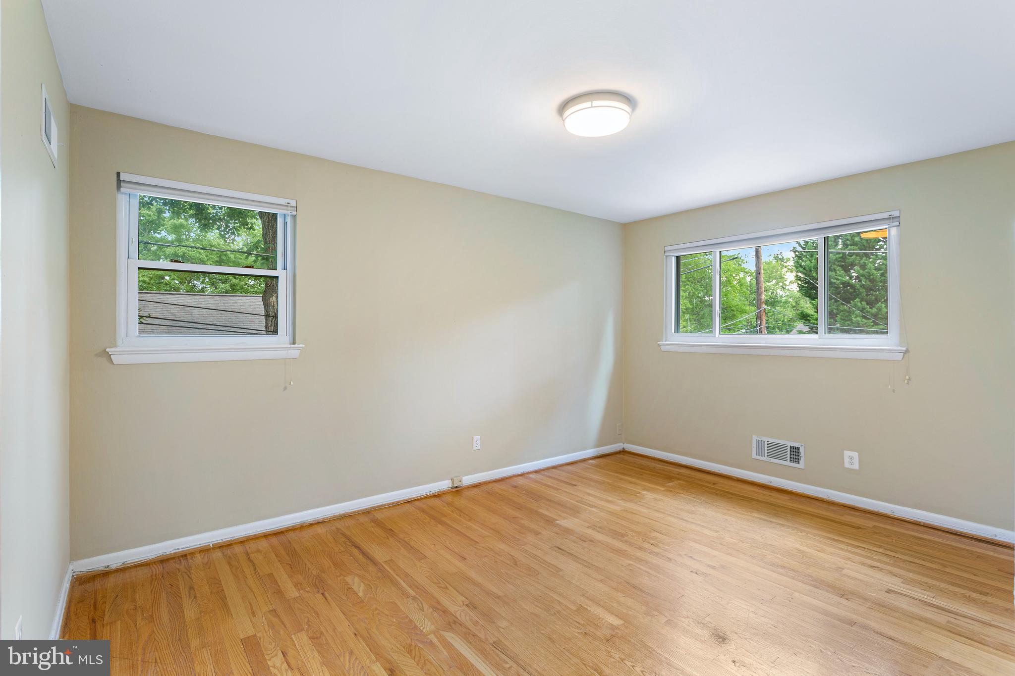 6503 Friars Court Bethesda, MD 20817 - Photo 33 of 48 a view of an empty room with wooden floor and a window