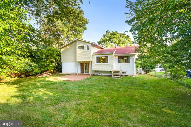 a view of a house with a yard and sitting area