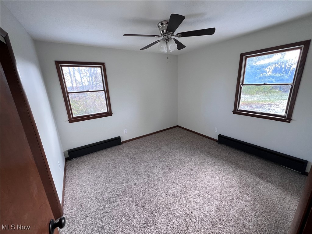 56376 Jordan Run Road Bellaire, OH 43906 - Photo 21 of 45 Carpeted spare room with ceiling fan and a baseboard radiator