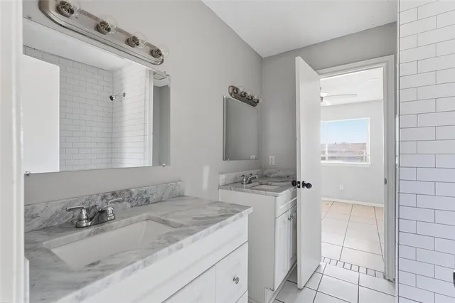 a bathroom with a sink toilet and mirror