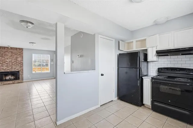a view of a kitchen with an empty space and a window