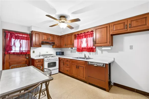 a kitchen with a stove a sink and a refrigerator
