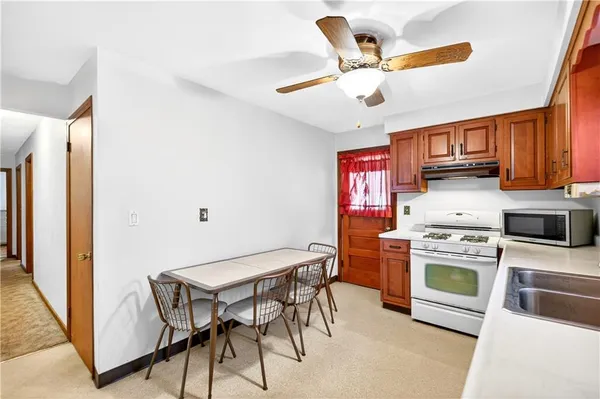 a kitchen with stainless steel appliances granite countertop a stove top oven a refrigerator a sink and dishwasher