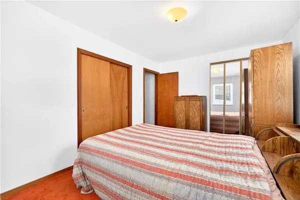 a bedroom with a bed and a cabinets